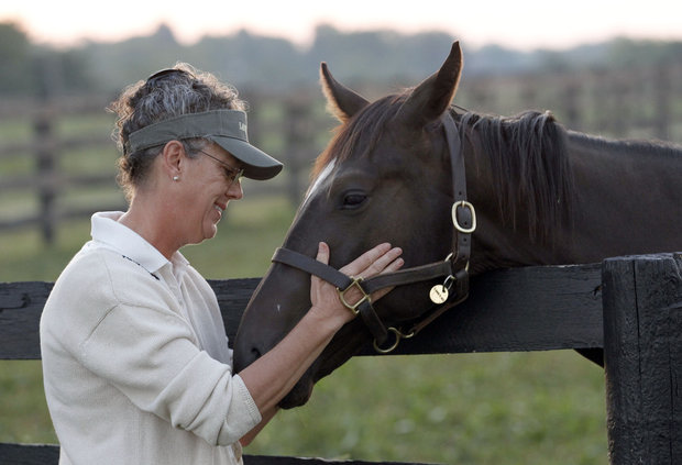 Suzi Shoemaker patted a yearling colt out of Summer Mis by Empire Maker on her Lantern Hill Farm  